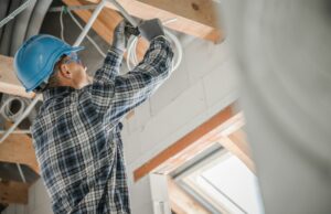 Electric Contractor Worker Installing Ceiling Light Point